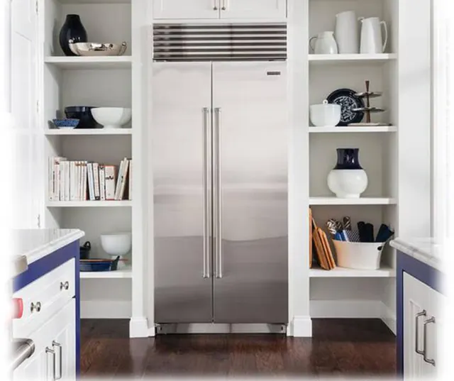 Stainless built-in side-by-side refrigerator between kitchen shelves