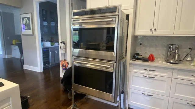 Stainless double wall oven in a white kitchen