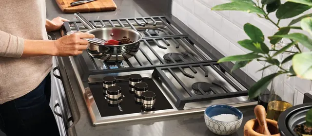 Cooking on a stainless gas cooktop