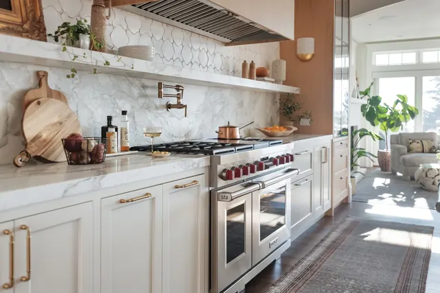 White kitchen with a dual-fuel range and open shelving